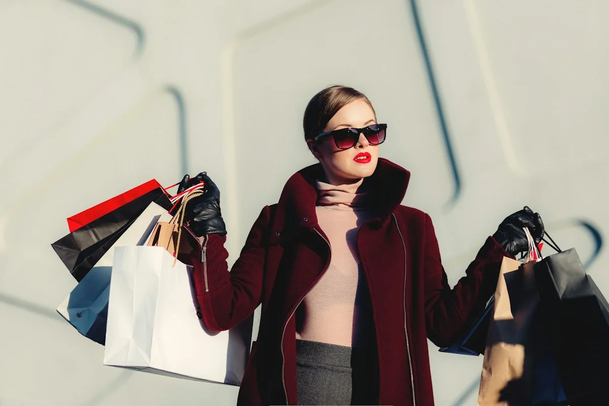 A shopper holding bags on a city street